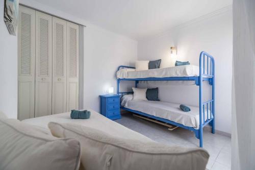 a bedroom with two bunk beds and a couch at Paseo Marítimo Rey de España in Fuengirola