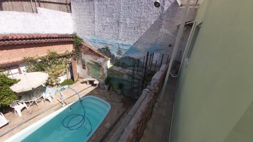 a view of a swimming pool from a balcony at Hostel Jardim da Saúde in São Paulo