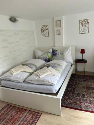 a white bed with pillows on it in a room at Apartment Harmony in Graz