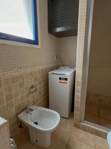a bathroom with a sink and a toilet and a shower at The Mayfair Village apto 305 in Patalavaca