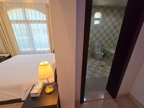 a bedroom with a bed and a bathroom with a tub at Stay Room Jumeriah Dubai in Dubai