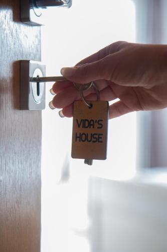 a person holding a padlock on a door at Vida`s house in Virpazar