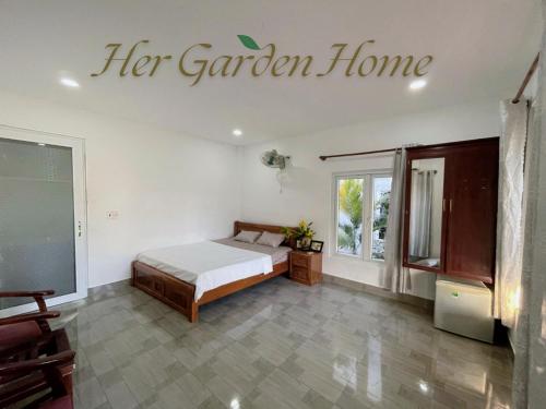 a bedroom with a bed and a sign that reads her garden home at Her Garden Home in Phu Quoc