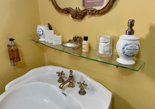 a bathroom with a white sink and a mirror at Ebenezer's Place in Broadstairs