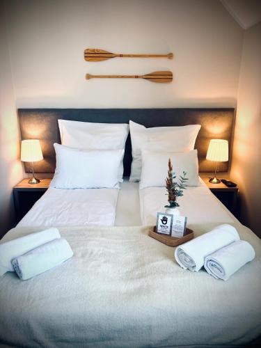 a white bed with towels and a christmas tree on it at Willa Aleksandra White Glove in Władysławowo