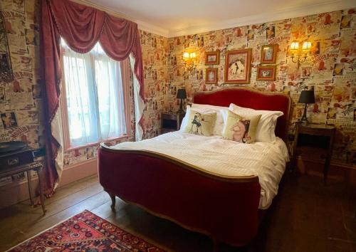 a bedroom with a large bed in a room with wallpaper at Ebenezer's Place in Broadstairs