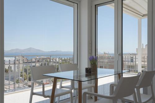 a dining room with a view of the ocean at Athenian Riviera Penthouse Apartment in Varkiza