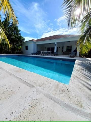 a large swimming pool in front of a house at Kolibri Central Villa in The Bight Settlements