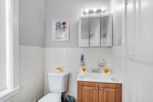 a bathroom with a toilet and a sink at Univ City Upenndrexel 2 Bdrm Lovely Unit in Philadelphia