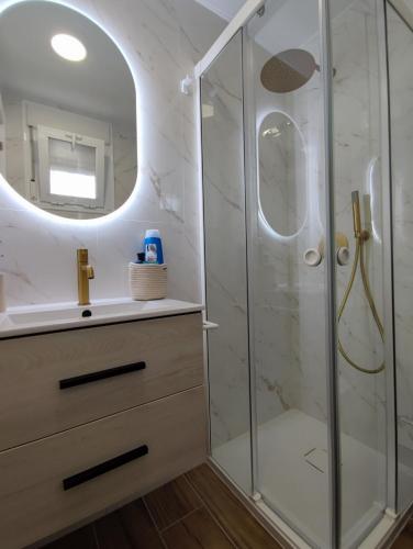 a bathroom with a shower with a sink and a mirror at ÁTICO TERESA BORA PALM, PISCINA PRIVADA CLIMATIZABLE 250m playa in Vera