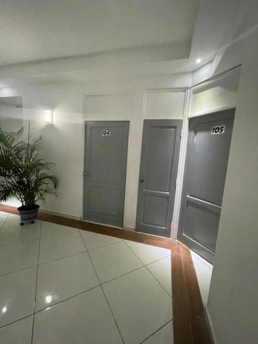 a hallway with three lockers in a building at Hotel Costa Linda Beach Boca Chica in Boca Chica