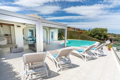 a patio with chairs and a swimming pool at Villa Smeralda in San Teodoro