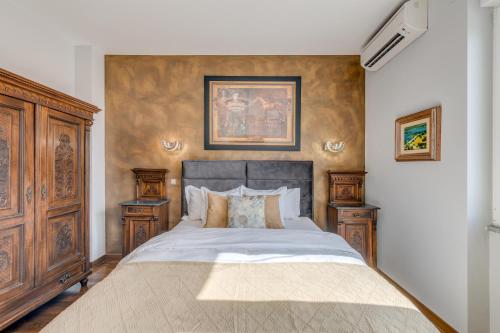 a bedroom with a large bed and two night stands at Grand Square Suite - Tale Of The City in Zagreb