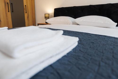 a close up of a bed with pillows on it at Apartman Paratetis 3 in Palić