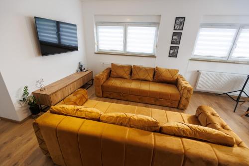 a living room with two couches and a couch at Apartman Paratetis 3 in Palić
