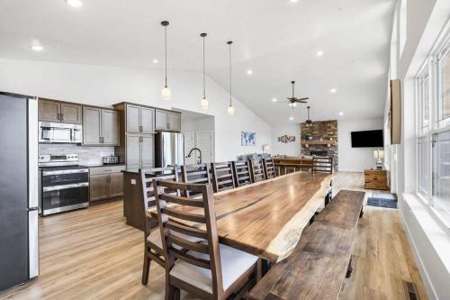 a kitchen with a large wooden table and chairs at The Lake Fish-Amazing Views-Sleeps 24-indoor-outdoor pools in Branson