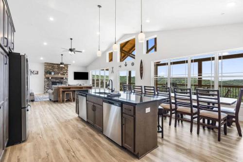 a kitchen and dining room with a table and chairs at The Lake Fish-Amazing Views-Sleeps 24-indoor-outdoor pools in Branson