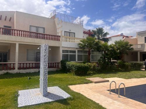 una casa con un poste delante de ella en Golden Beach Villa Casablanca, en Sidi Rahal