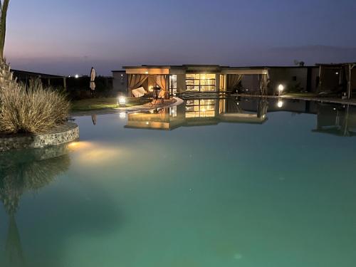 a house with a swimming pool at night at Dar Tiziri Amizmiz in Marrakech
