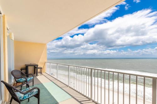 a balcony with two chairs and a view of the ocean at San Carlos 1503 in Gulf Shores