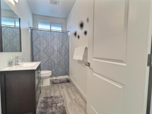 a bathroom with a toilet and a sink and a shower at Sonoma Grove Suites in Sonoma