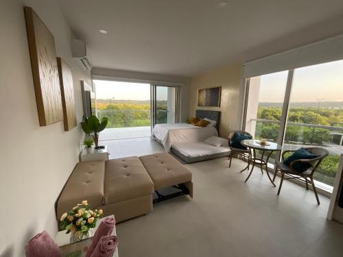 Sala de estar con sofá, cama y mesa en Loft de Lujo Cartagena - Salida Directa Al Mar - Piscinas - Jacuzzi en Morros, en Cartagena de Indias