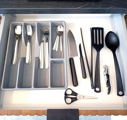 a utensil tray with cutlery in a drawer at AlfaHome ManuPark in Łódź