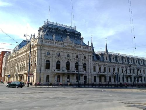a large building with a car parked in front of it at AlfaHome ManuPark in Łódź
