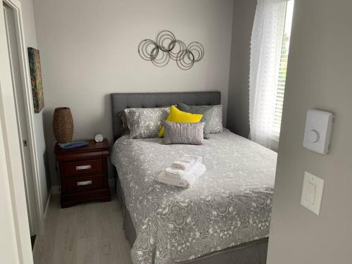 a bedroom with a bed with towels on it at LOCATION LOCATION LOCATION IMMACULATE 1 BEDROOM SUITE in Victoria