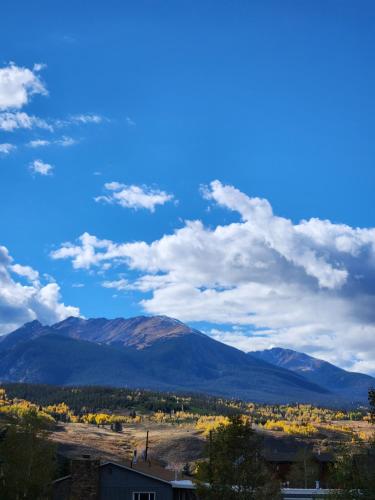 a view of a mountain with a blue sky and clouds at Luxury Inn & Suites in Silverthorne