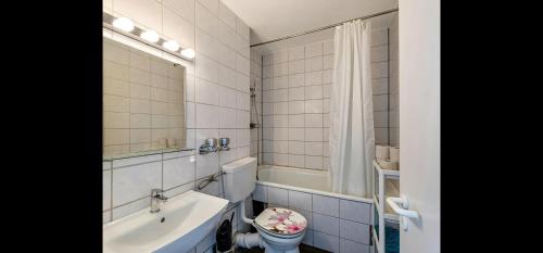 a bathroom with a sink and a toilet and a tub at Stunning 1-Bed Apartment in Neuss in Neuss