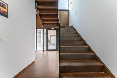 a staircase leading up to a building with wooden floors at CMDreams Platinium- Apartamentos turísticos en el centro de Mérida in Merida