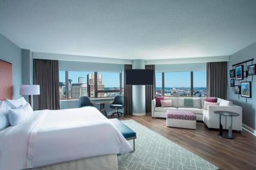 a hotel room with a bed and a living room at The Westin Copley Place, Boston in Boston