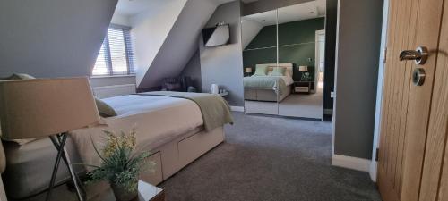 a bedroom with a large bed and a mirror at Causeway Rooms 
