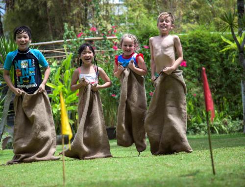 three children dressed in costumes standing in a yard at Prime Plaza Suites Sanur – Bali in Sanur