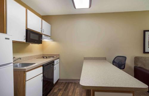 a small kitchen with a sink and a counter at Extended Stay America Select Suites - Jacksonville Salisbury Rd Southpoint in Jacksonville