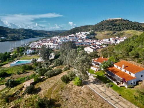 an aerial view of a town on a hill at Casas Rurales Los Molinos in Sanlúcar de Guadiana