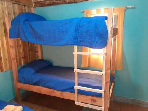 a bunk bed with a ladder in a room at Camping El Bosque in El Hoyo