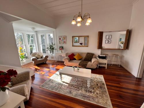 a living room with a couch and a table at La Casa Bonita Auckland in Auckland