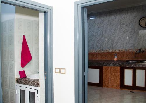 a bathroom with a sink and a sliding glass door at Luxury Fes Villa in Fès