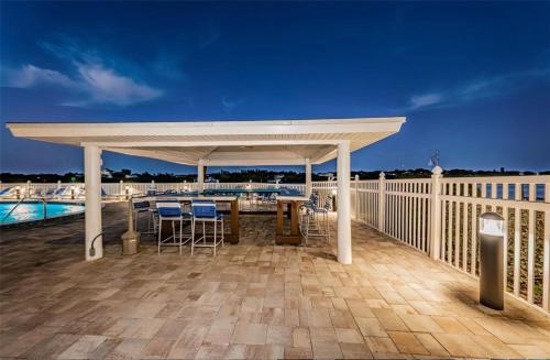 a pavilion on a deck with a table and chairs at Bayshore Yatch Tennis Condo 2br 3 beds, Walking Distance to Beautiful Quite Beach in Clearwater Beach