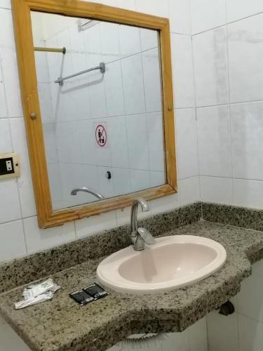a bathroom counter with a sink and a mirror at Rezeiky Hotel & Camp in Luxor