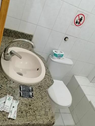 a bathroom with a white toilet and a sink at Rezeiky Hotel & Camp in Luxor