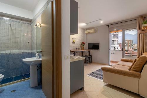 a bathroom with a sink and a toilet and a shower at NEW BAZAAR Apartment in Tirana