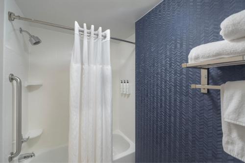 a bathroom with a shower with a white shower curtain at Fairfield Inn Boston Tewksbury/Andover in Tewksbury
