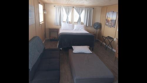 a small bedroom with a bed and a couch at StarGazer Hidaway in Bisbee