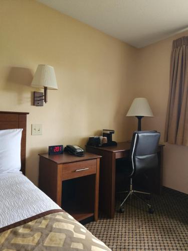 a hotel room with a bed and a desk and a chair at Luxury Inn & Suites in Silverthorne
