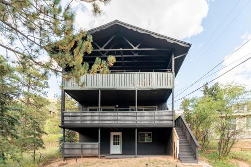 a house with a balcony on the side of it at Blue Sparrow's Nest in Green Mountain Falls