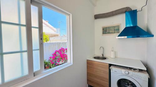 a kitchen with a washing machine and a window at Dream home in Amora