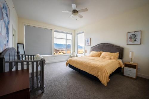a bedroom with a bed and a large window at Mountain Retreat with Views, Hot Tub, Games & AC in Chilliwack